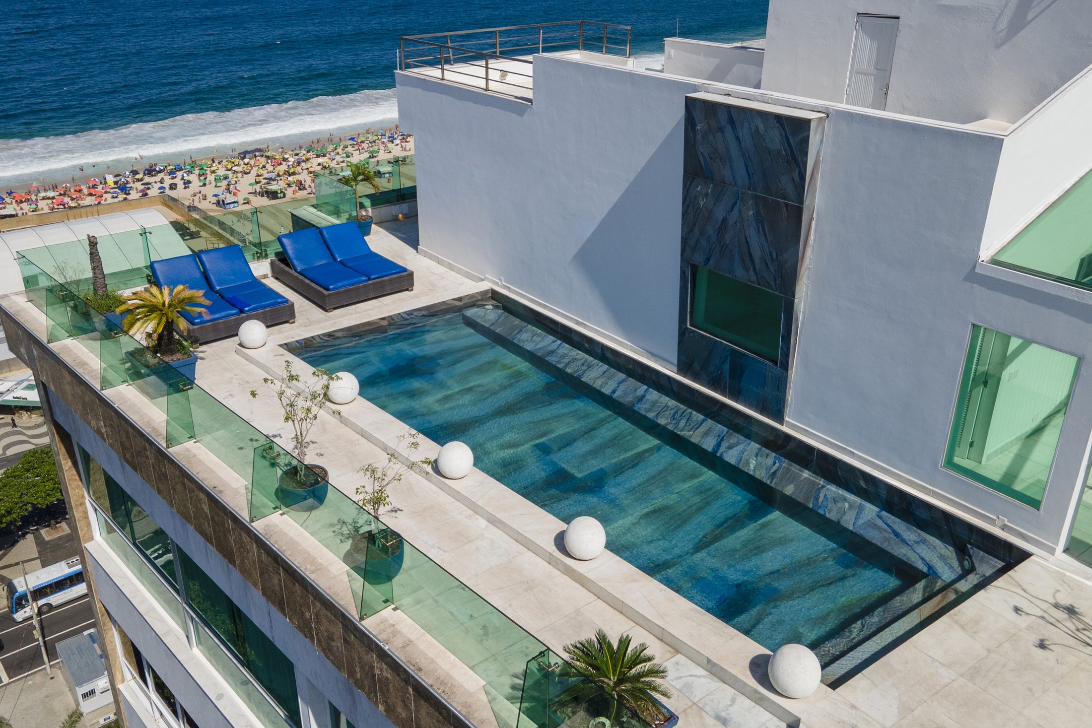 Aerial view of the ADV 001 rooftop pool and sun loungers above Copacabana beach